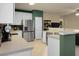 Modern kitchen showcasing stainless steel refrigerator and seamless flow into dining and living areas at 1026 Briar Rose Ln, Ladson, SC 29456