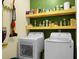Laundry room featuring washer, dryer, and shelves with laundry supplies at 1026 Briar Rose Ln, Ladson, SC 29456