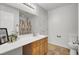 Well-lit bathroom features a stylish vanity, toilet, and patterned shower curtain at 108 Larkspur Dr, Goose Creek, SC 29445