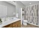 Modern bathroom featuring wooden vanity, sleek sink, decorative accents, and ample lighting at 108 Larkspur Dr, Goose Creek, SC 29445