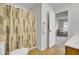 Bright bathroom with neutral shower curtain, toilet, and view into the living area at 108 Larkspur Dr, Goose Creek, SC 29445