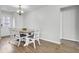 Cozy dining area with a wooden table, white chairs, and wood-look floors, near the entryway at 108 Larkspur Dr, Goose Creek, SC 29445