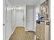 Bright hallway featuring wood-look floors, neutral paint, and access to various rooms at 108 Larkspur Dr, Goose Creek, SC 29445