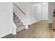 Hallway features wood flooring, a carpeted staircase, and white walls at 108 Larkspur Dr, Goose Creek, SC 29445