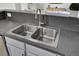 Close-up of a modern kitchen sink with stainless steel fixtures and a sleek countertop, perfect for easy cleanup at 108 Larkspur Dr, Goose Creek, SC 29445