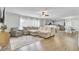 Spacious living room with natural light, wood floors, and an open layout to the kitchen and dining area at 108 Larkspur Dr, Goose Creek, SC 29445