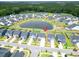 High angle aerial view of houses in a circular neighborhood featuring a pond in the center at 112 Whisper Dr, Summerville, SC 29485