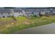 An aerial view showcasing the backyard and pond with beautiful houses and green lawns at 112 Whisper Dr, Summerville, SC 29485