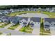 Aerial view showcasing a neighborhood with a beautiful pond and well-maintained lawns and homes at 112 Whisper Dr, Summerville, SC 29485