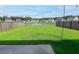 Spacious backyard with green lawn, wood fence, and scenic pond views offering a tranquil outdoor space at 112 Whisper Dr, Summerville, SC 29485