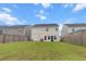 A well-maintained backyard with lush green grass and white vinyl siding on a sunny day at 112 Whisper Dr, Summerville, SC 29485