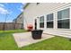 Spacious backyard with a patio, fire pit, and well-maintained lawn perfect for outdoor entertaining at 112 Whisper Dr, Summerville, SC 29485