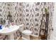 Stylish powder room featuring unique wallpaper and modern fixtures, adding character and convenience at 112 Whisper Dr, Summerville, SC 29485