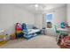 Cozy bedroom featuring a daybed, rainbow dresser, string lights, and a window with backyard views at 112 Whisper Dr, Summerville, SC 29485