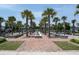 Scenic community area featuring a linear fountain, brick pathways, palm trees, and lounge seating at 112 Whisper Dr, Summerville, SC 29485