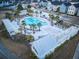Aerial view of the community pool with lounge chairs and palm trees at 112 Whisper Dr, Summerville, SC 29485