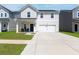 Charming two-story home featuring white siding, a well-manicured lawn, and an attached two-car garage at 112 Whisper Dr, Summerville, SC 29485