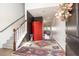 A welcoming foyer with a staircase, a colorful rug, and a glimpse into the open-concept living space at 112 Whisper Dr, Summerville, SC 29485