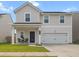 Charming two-story home with a covered front porch, well-manicured lawn, and a two-car garage at 112 Whisper Dr, Summerville, SC 29485