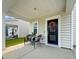 Inviting front porch featuring stylish chairs, a wreath, and a charming entryway for a warm welcome at 112 Whisper Dr, Summerville, SC 29485