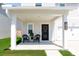Inviting covered front porch featuring two chairs and a wreath on the front door at 112 Whisper Dr, Summerville, SC 29485