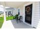 Inviting front porch with a charming wreath on the front door and comfortable chairs for relaxing at 112 Whisper Dr, Summerville, SC 29485