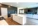 Open-concept kitchen with stainless steel appliances, island sink, and quartz countertops seamlessly flows to living area at 112 Whisper Dr, Summerville, SC 29485