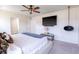 A brightly lit main bedroom with ceiling fan, television, and a hanging light fixture at 112 Whisper Dr, Summerville, SC 29485