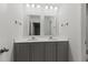 Well-lit bathroom features a double sink vanity with gray cabinets and dual mirrors at 113 Petrell Rd, Summerville, SC 29483