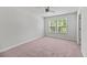 Bright bedroom features a ceiling fan, a double window with views, and neutral carpet at 113 Petrell Rd, Summerville, SC 29483