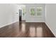 Bright living room featuring hardwood floors, white walls, and large windows overlooking the front yard at 113 Petrell Rd, Summerville, SC 29483
