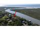 Aerial view of the home on a waterway with lush greenery, a private dock and ocean views at 1195 Framptons Inlet Rd, Edisto Island, SC 29438