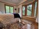 Serene bedroom with hardwood floors, triple windows, and a cozy window seat at 1195 Framptons Inlet Rd, Edisto Island, SC 29438