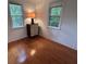 A bedroom with hardwood floors and natural light from the exterior windows at 1195 Framptons Inlet Rd, Edisto Island, SC 29438