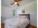 Cozy bedroom with a ceiling fan, wood floors and natural light from the exterior window at 1195 Framptons Inlet Rd, Edisto Island, SC 29438