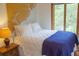 Comfortable bedroom with a map art piece, side table lamp, and window views at 1195 Framptons Inlet Rd, Edisto Island, SC 29438