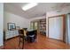 Versatile bonus room with a built-in bookshelf, storage, hardwood floors, and abundant natural light at 1195 Framptons Inlet Rd, Edisto Island, SC 29438