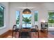 Cozy breakfast nook featuring a glass table, bay window with serene views, and hardwood floors at 1195 Framptons Inlet Rd, Edisto Island, SC 29438