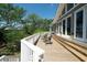 Large wood deck with white railings, ideal for entertaining or enjoying the scenic outdoor surroundings at 1195 Framptons Inlet Rd, Edisto Island, SC 29438