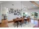 Stylish dining room with hardwood floors, modern lighting, gallery wall and views of the outdoor scenery at 1195 Framptons Inlet Rd, Edisto Island, SC 29438