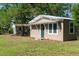 Quaint home with charming details, showcasing a well-maintained exterior and serene setting at 1195 Framptons Inlet Rd, Edisto Island, SC 29438