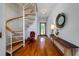 Bright foyer boasts an elegant spiral staircase and hardwood floors, creating a grand entrance at 1195 Framptons Inlet Rd, Edisto Island, SC 29438