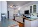 Bright kitchen with white cabinets, patterned backsplash, and modern appliances with backyard view at 1195 Framptons Inlet Rd, Edisto Island, SC 29438