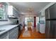 A charming kitchen featuring painted cabinets, stainless steel appliances and warm hardwood floors at 1195 Framptons Inlet Rd, Edisto Island, SC 29438
