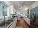 Bright kitchen with stainless appliances, tile backsplash, hardwood floors, and an eat in area at 1195 Framptons Inlet Rd, Edisto Island, SC 29438