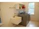 Bright laundry room with modern machines and an adjacent utility sink at 1195 Framptons Inlet Rd, Edisto Island, SC 29438