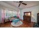 Cozy living room with hardwood floors, vintage furnishings, and bright natural light at 1195 Framptons Inlet Rd, Edisto Island, SC 29438