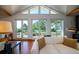 Bright living room featuring vaulted ceilings, hardwood floors, and expansive windows with scenic outdoor views at 1195 Framptons Inlet Rd, Edisto Island, SC 29438
