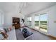 Bright living room with balcony access offers panoramic water views with sliding glass doors at 1195 Framptons Inlet Rd, Edisto Island, SC 29438
