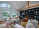 Sun-drenched living area with a custom built-in shelving unit, and comfortable seating offering a view of the outdoors at 1195 Framptons Inlet Rd, Edisto Island, SC 29438